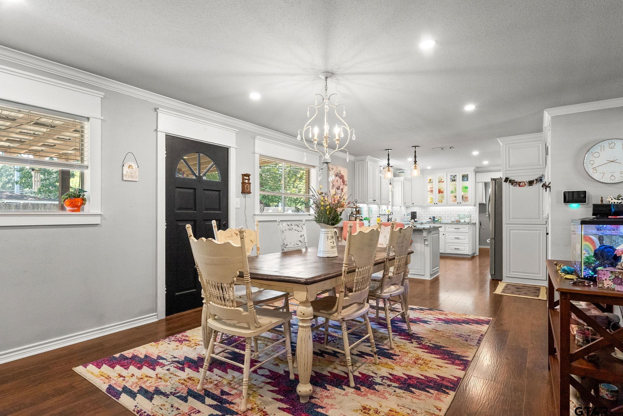 3200 Charron Avenue Longview, TX 75601 - Photo 6 of 34 a dining room with furniture a chandelier and wooden floor