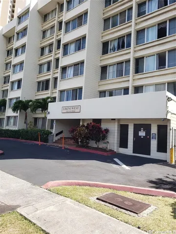 a front view of a building with a garden