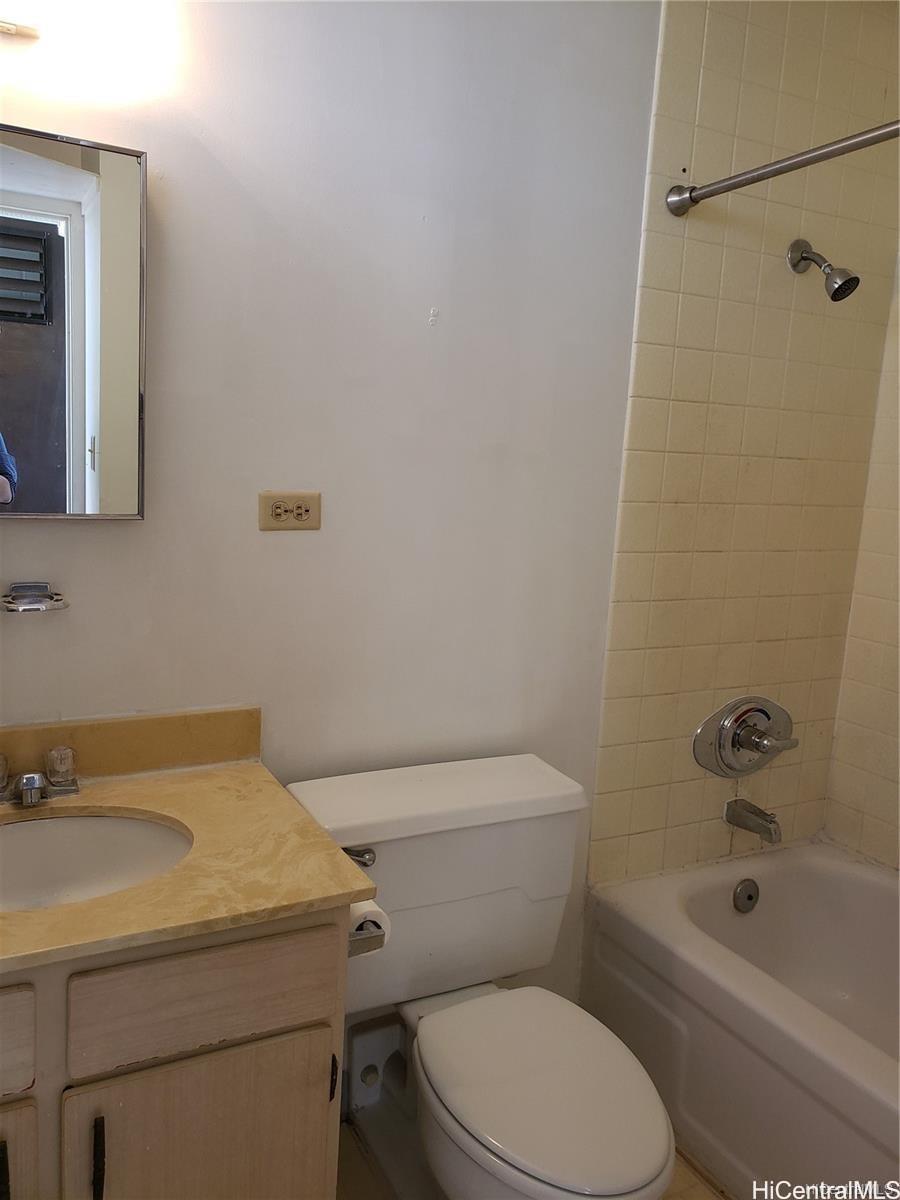 5122 Likini Street, Unit 716 Honolulu, HI 96818 - Photo 5 of 9 a white toilet sitting next to a bath tub