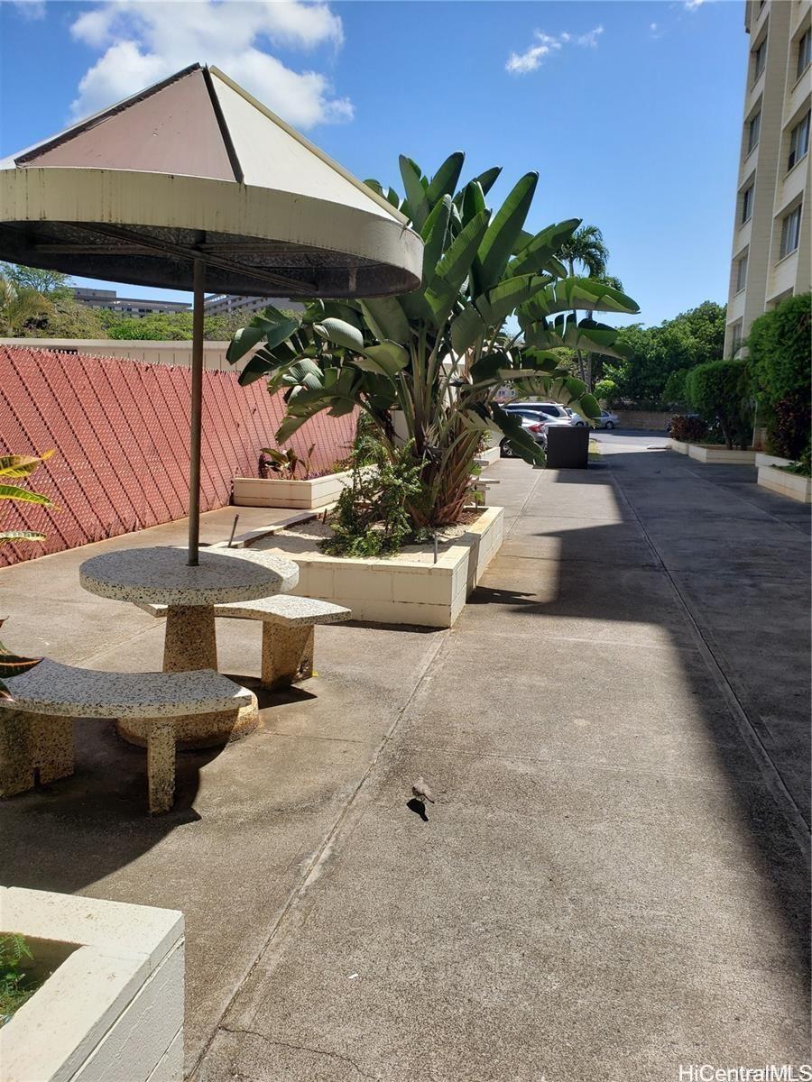 5122 Likini Street, Unit 716 Honolulu, HI 96818 - Photo 9 of 9 a view of a patio with table and chairs potted plants
