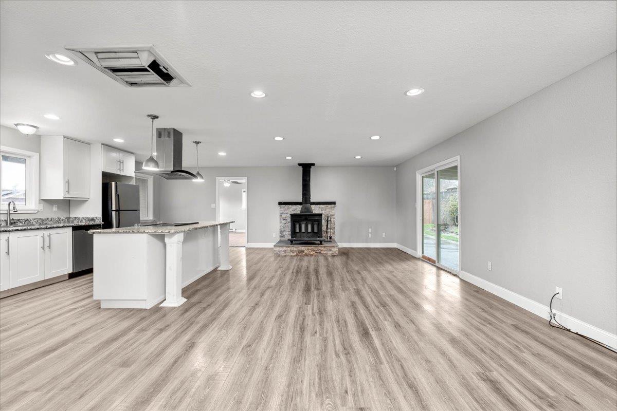 20381 Nashua Road Sonora, CA 95370 - Photo 8 of 27 a living room with kitchen island furniture and a wooden floor