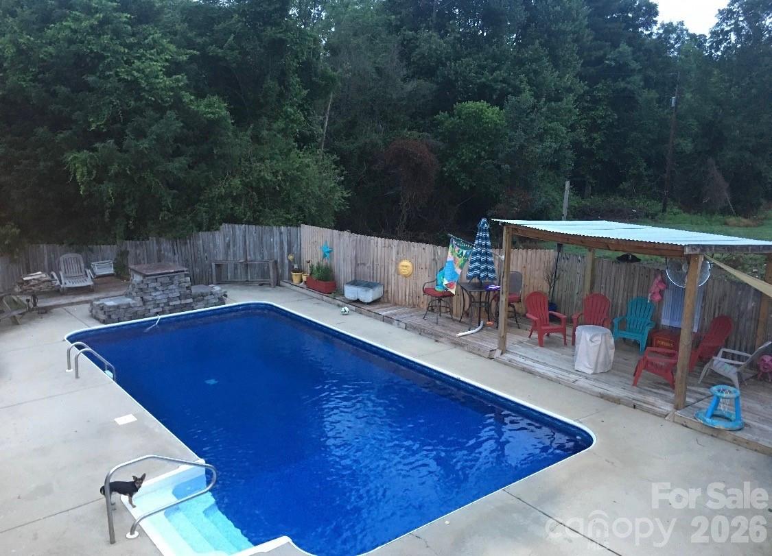 4132 Lower Cedar Valley Road Hudson, NC 28638 - Photo 5 of 5 a patio with water fountain table and chairs