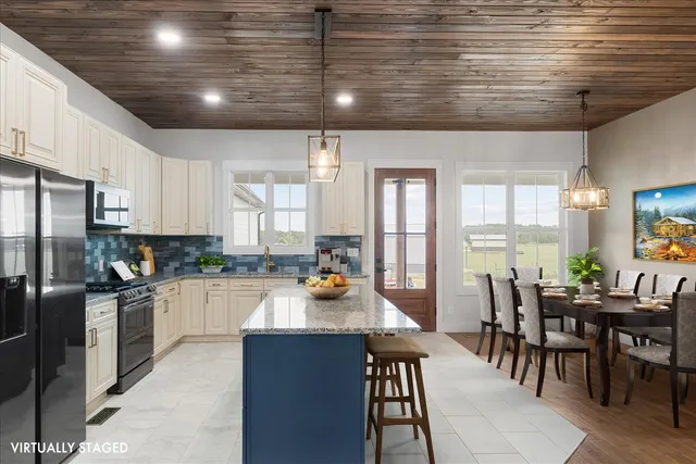 a kitchen with a table chairs stove and refrigerator
