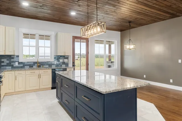 a kitchen with granite countertop cabinets a sink and dishwasher