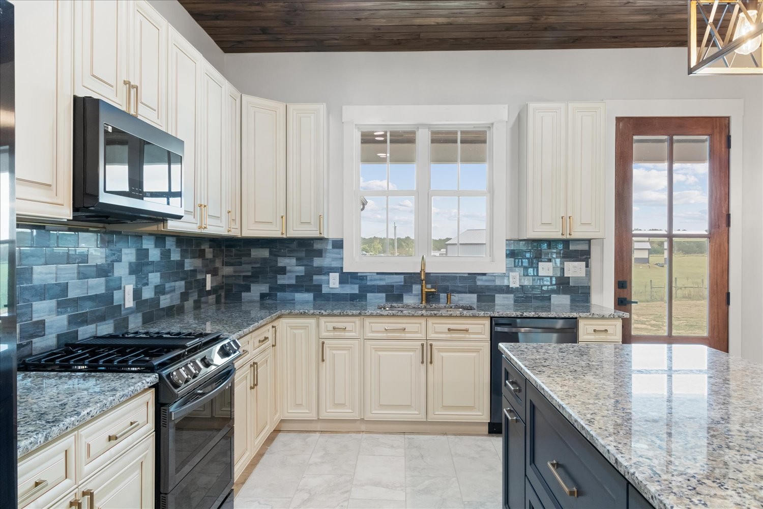 136 Summer Lk Drive Summertown, TN 38483 - Photo 20 of 48 a kitchen with stainless steel appliances granite countertop a stove a sink and a microwave