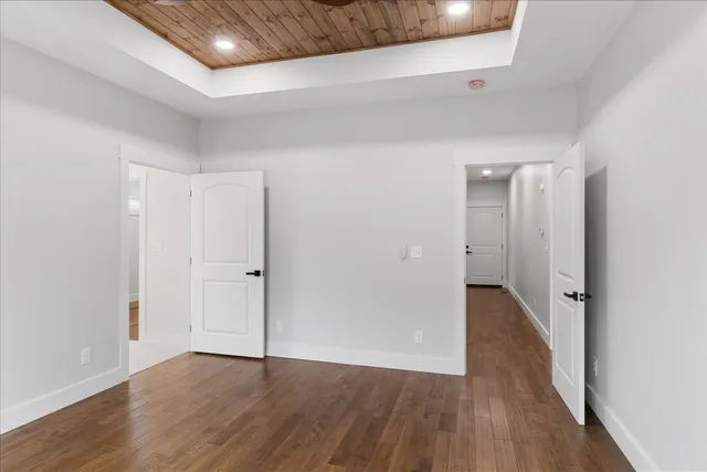 a view of a hallway with wooden floor
