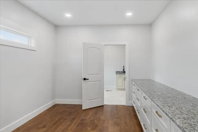 a view of a kitchen cabinets and wooden floor