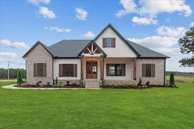 a front view of house with yard and green space