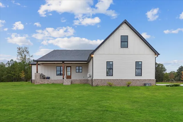 a front view of house with yard and green space