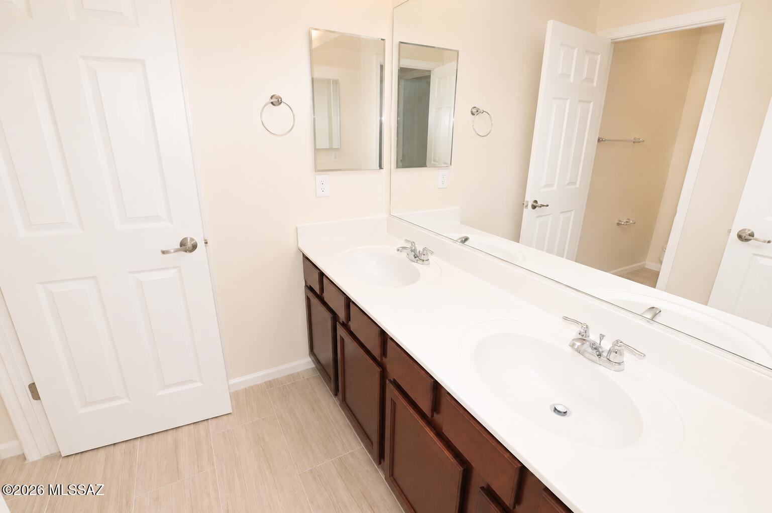 11484 East Desert Raptor Loop Tucson, AZ 85747 - Photo 4 of 28 a bathroom with a double vanity sink and mirror