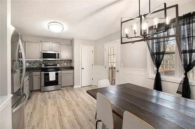 a kitchen with granite countertop a sink and stainless steel appliances