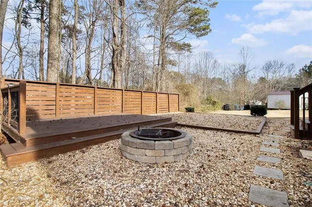 a view of a house with a backyard