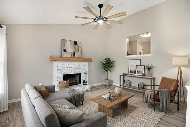 wooden floor fireplace and window in an empty room