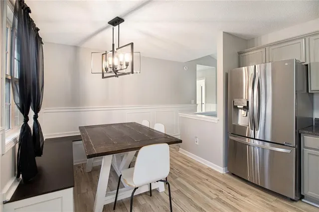 a kitchen with granite countertop a refrigerator stove top oven and sink