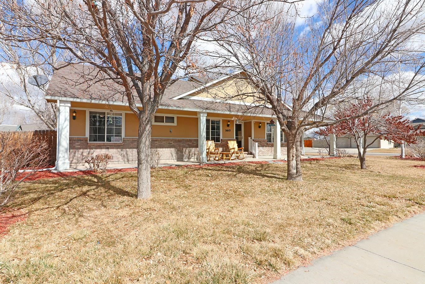 307 Elderberry Drive Fruita, CO 81521 - Photo 2 of 42 a front view of a house with a yard covered in snow