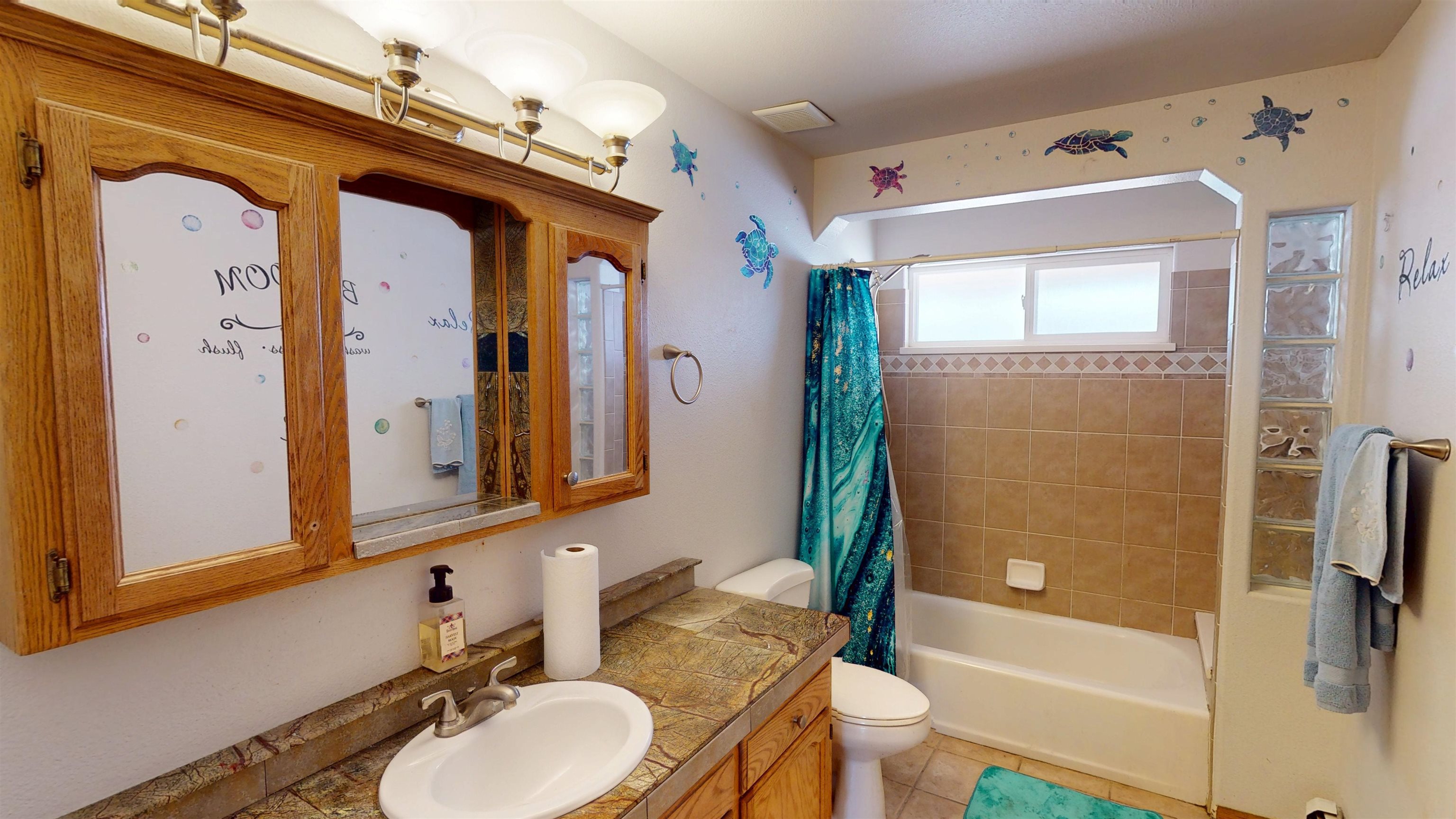 307 Elderberry Drive Fruita, CO 81521 - Photo 23 of 42 a bathroom with a sink a toilet and a large mirror