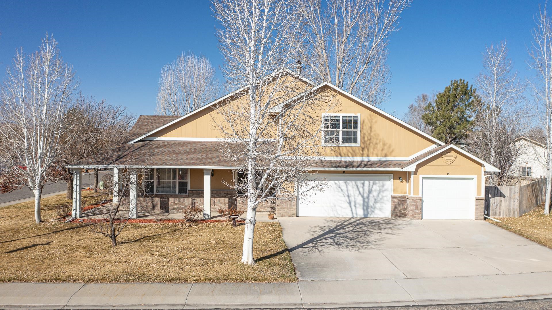 307 Elderberry Drive Fruita, CO 81521 - Photo 39 of 42 a front view of a house with a yard and porch