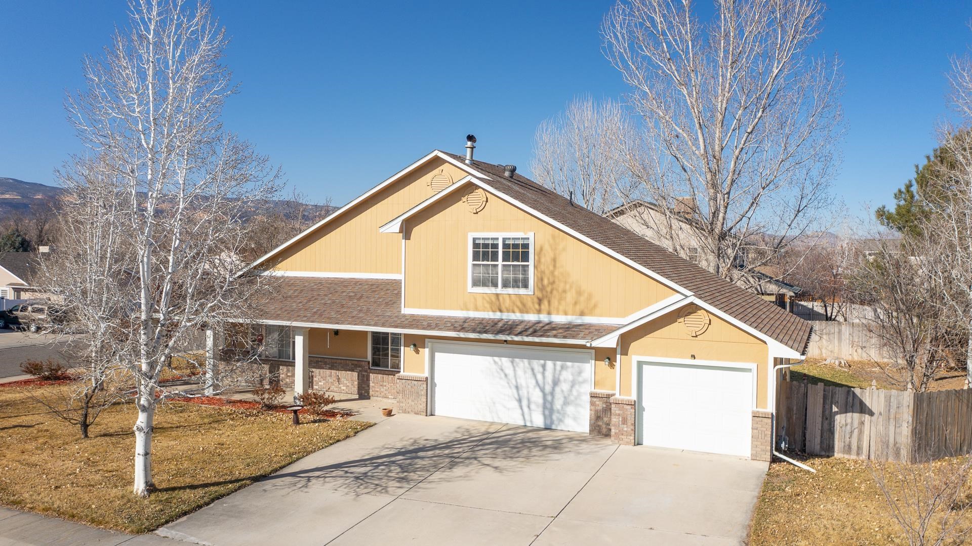 307 Elderberry Drive Fruita, CO 81521 - Photo 40 of 42 a front view of a house with a garden