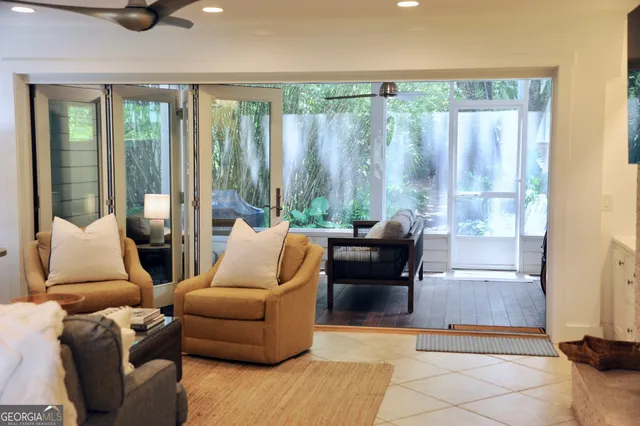 a living room with furniture and a floor to ceiling window