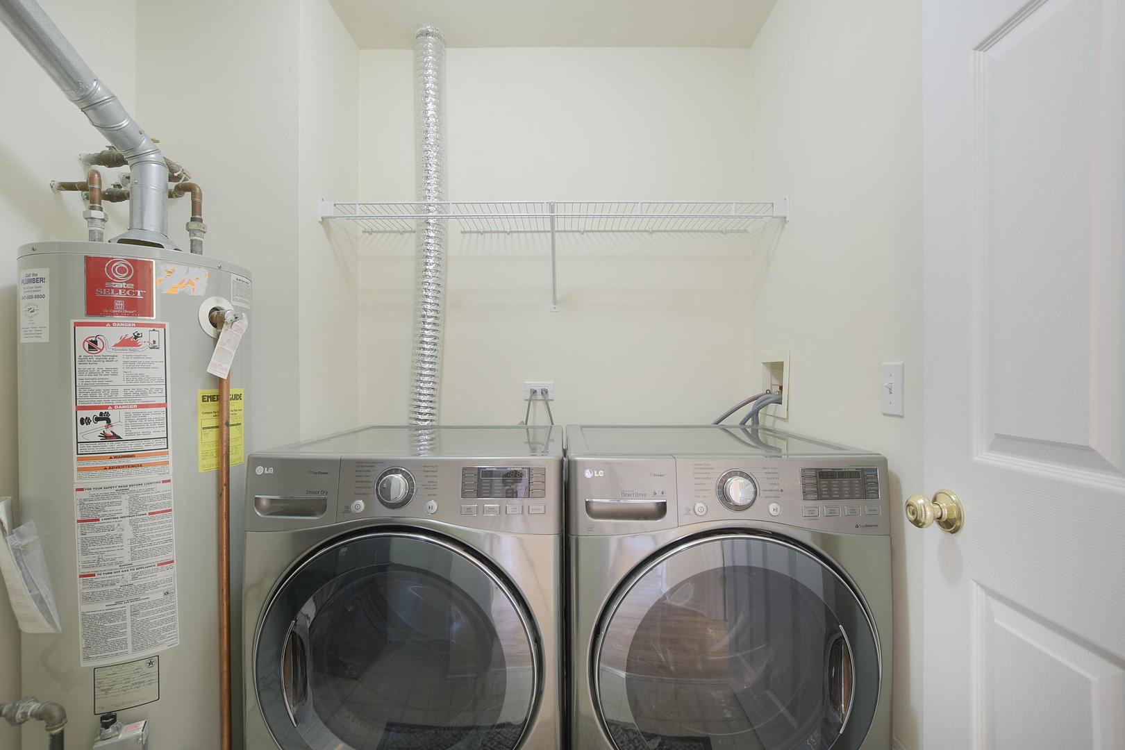 670 Mill Circle, Unit 3005 Wheeling, IL 60090 - Photo 20 of 22 a view of a storage & utility room with dryer and washer