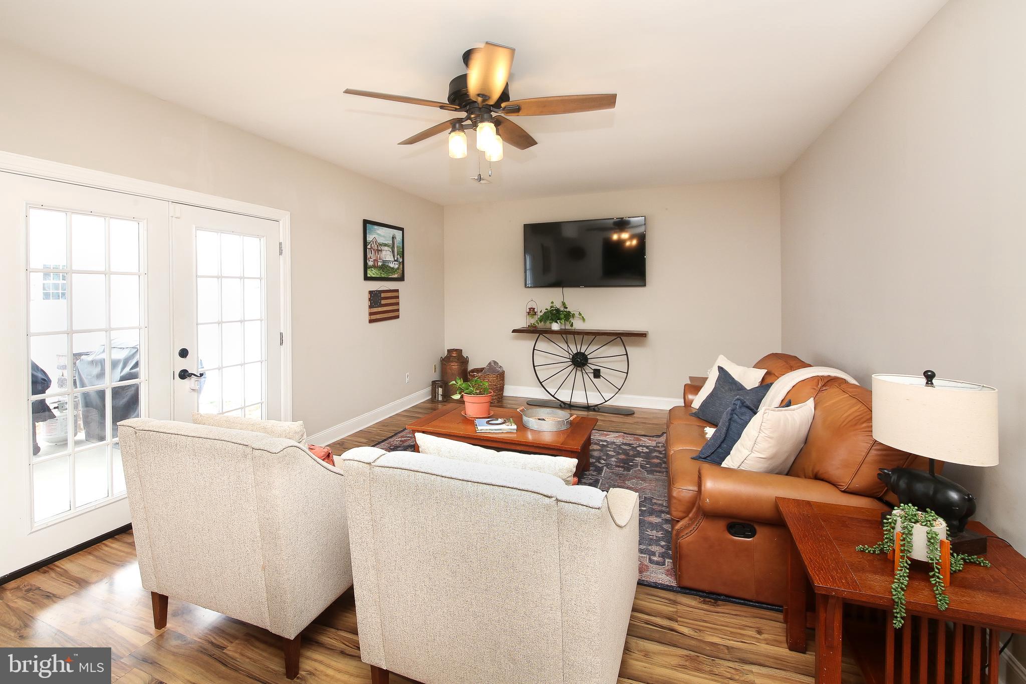1148 Independence Way Hatfield, PA 19440 - Photo 13 of 33 a living room with furniture a flat screen tv and wooden floor