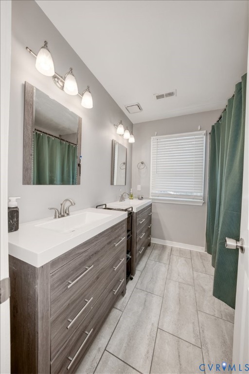 11201 Puckett Place Midlothian, VA 23112 - Photo 15 of 23 a large bathroom with a double vanity sink a large mirror and a bathtub