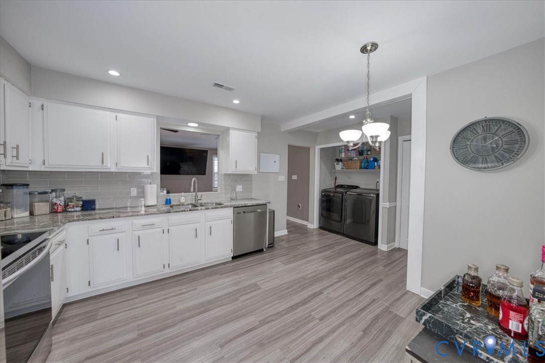 11201 Puckett Place Midlothian, VA 23112 - Photo 6 of 23 a large kitchen with lots of counter space and stainless steel appliances