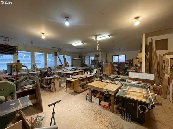 a room with gym equipment and a view of living room