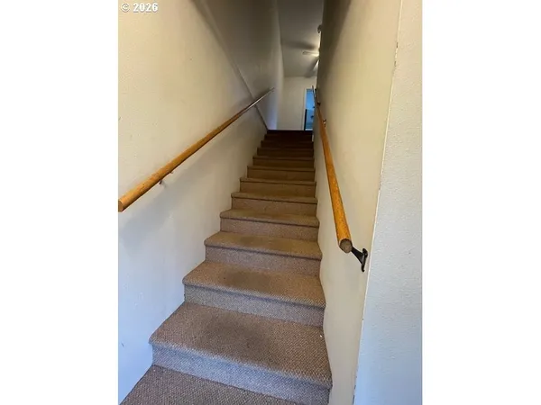 an empty room with closet and a ceiling fan