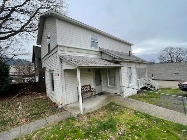a view of a house with a tree