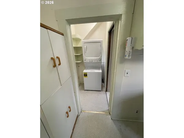 a kitchen with a refrigerator and a stove top oven