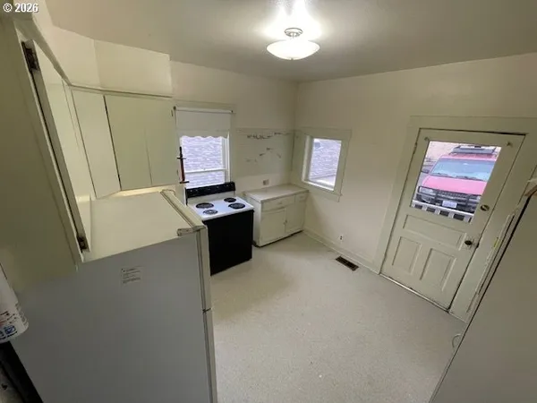 a view of an empty room and wooden floor