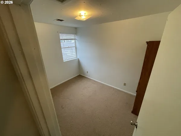 a bathroom with a toilet and a mirror