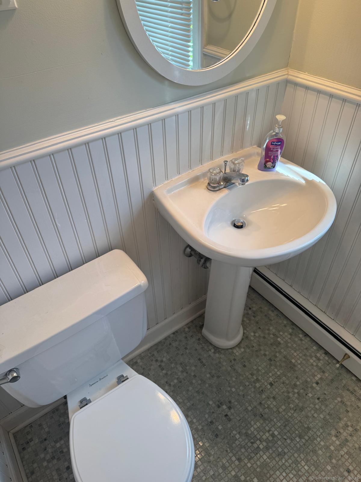 18 Hales Road Westport, CT 06880 - Photo 11 of 26 a bathroom with a sink a toilet and a mirror