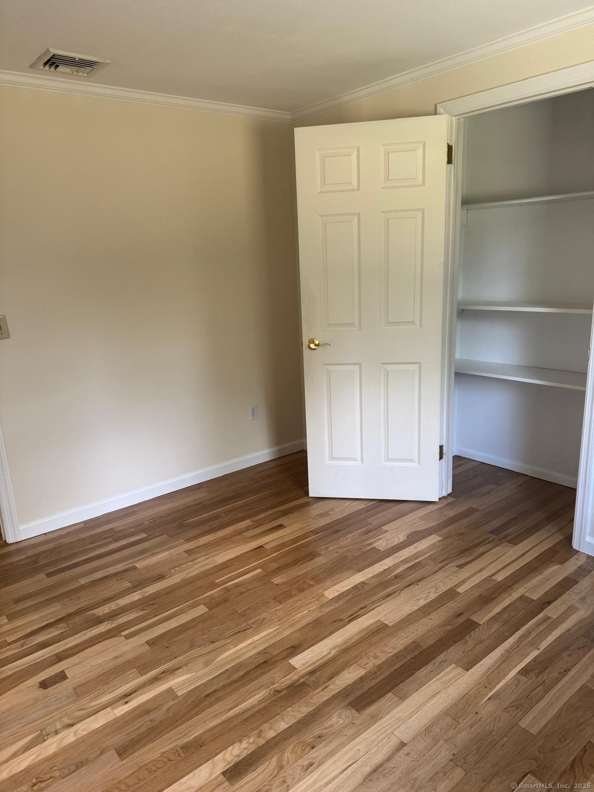 18 Hales Road Westport, CT 06880 - Photo 15 of 26 a view of an empty room with wooden floor and closet