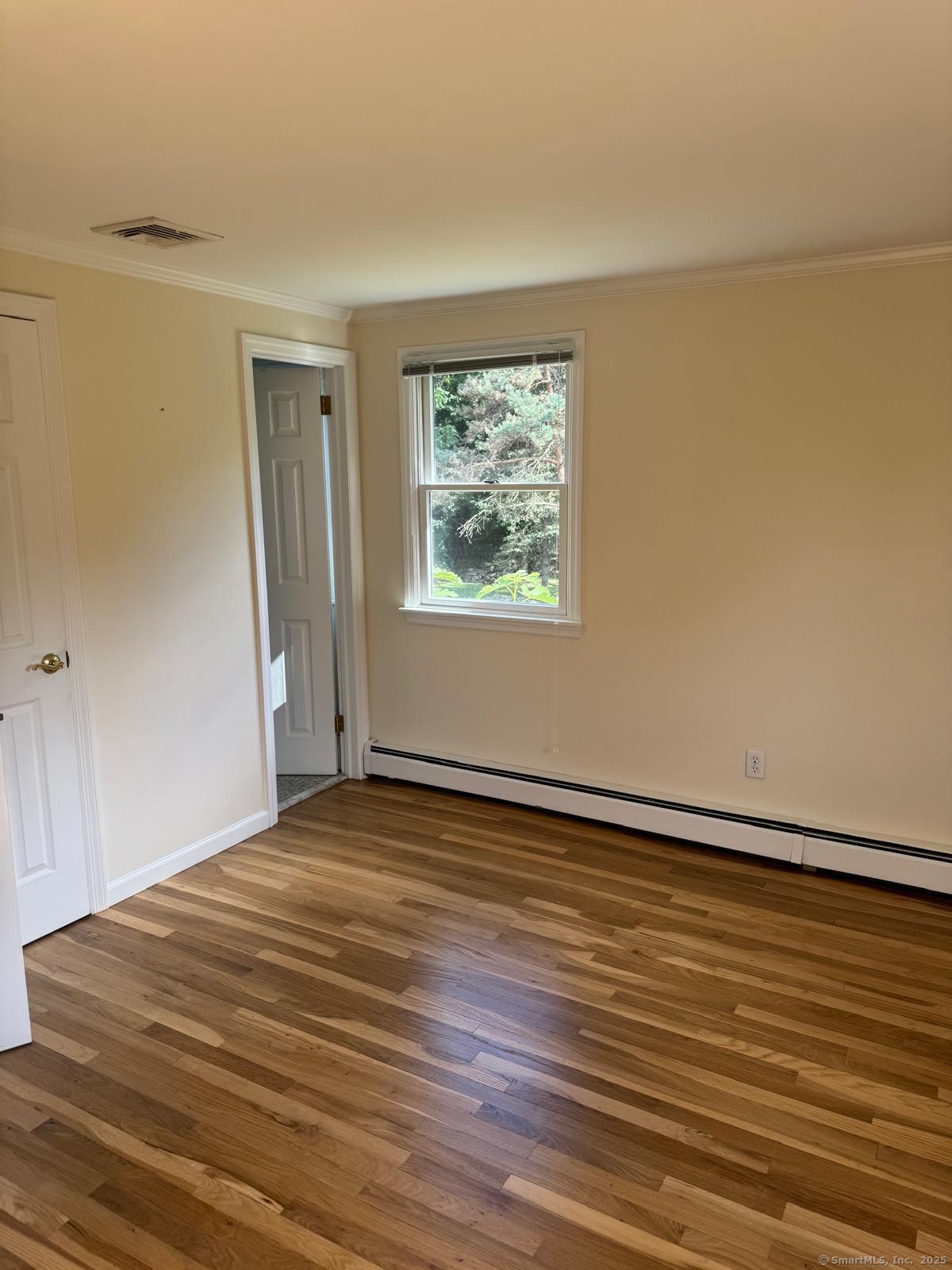 18 Hales Road Westport, CT 06880 - Photo 9 of 26 a view of an empty room with wooden floor and a window