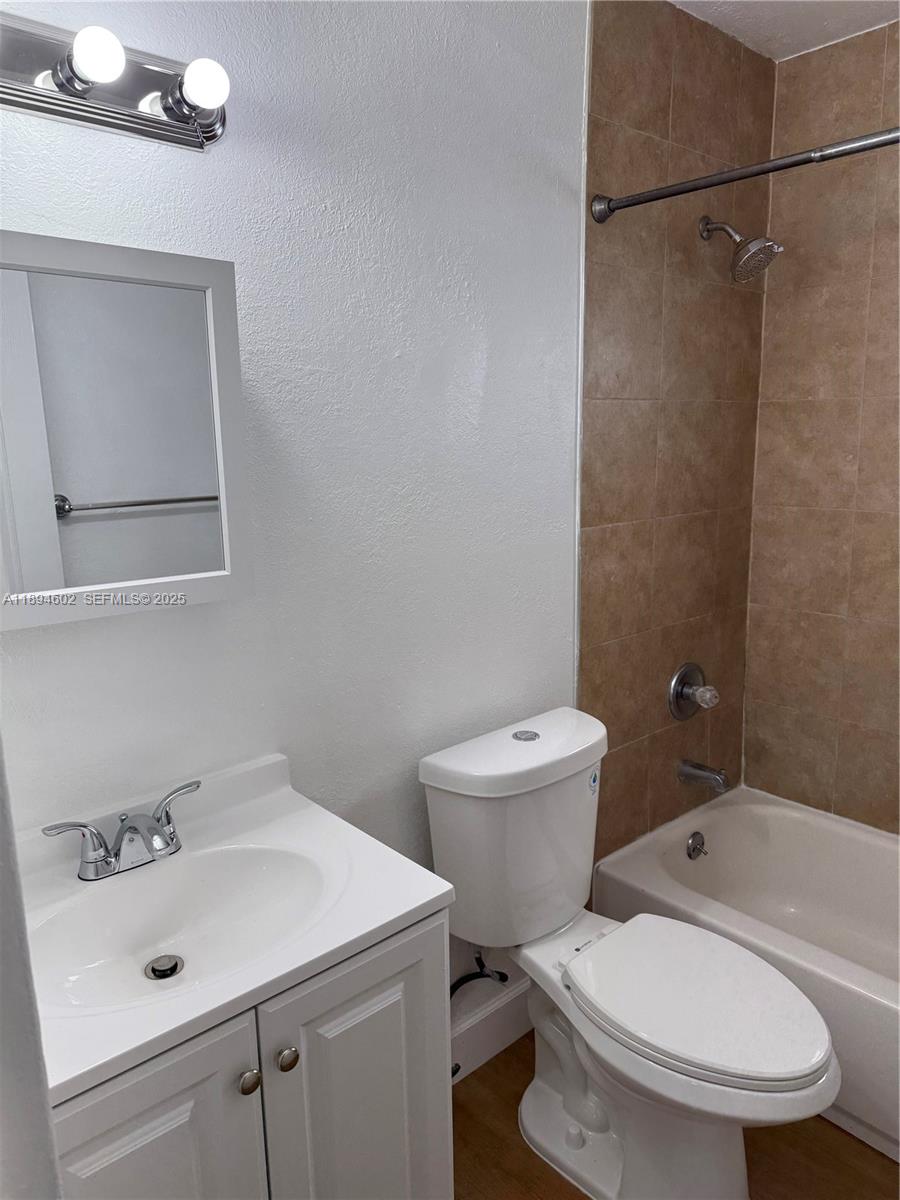 180 Northeast 71st Street, Unit 5 Miami, FL 33138 - Photo 9 of 12 a bathroom with a sink toilet and shower