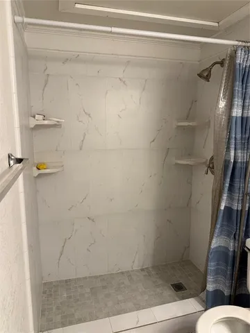 a spacious bathroom with a double vanity sink toilet and mirror