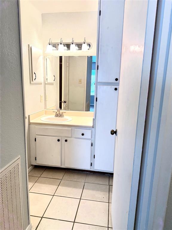 2240 Tarpley Road, Unit 31 Carrollton, TX 75006 - Photo 16 of 18 a bathroom with a double vanity sink and mirror