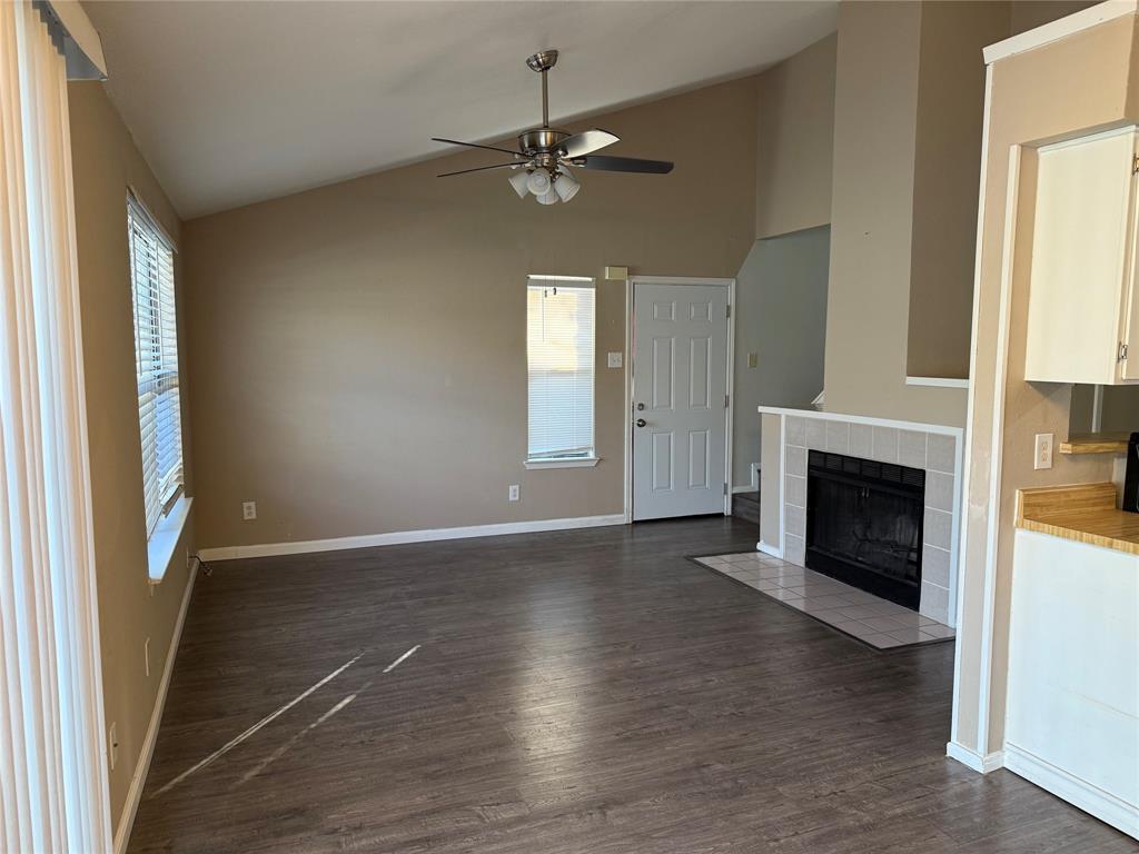 2240 Tarpley Road, Unit 31 Carrollton, TX 75006 - Photo 4 of 18 an empty room with wooden floor fireplace and windows