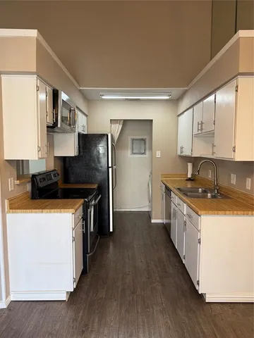 a kitchen with stainless steel appliances granite countertop a sink a stove and a refrigerator