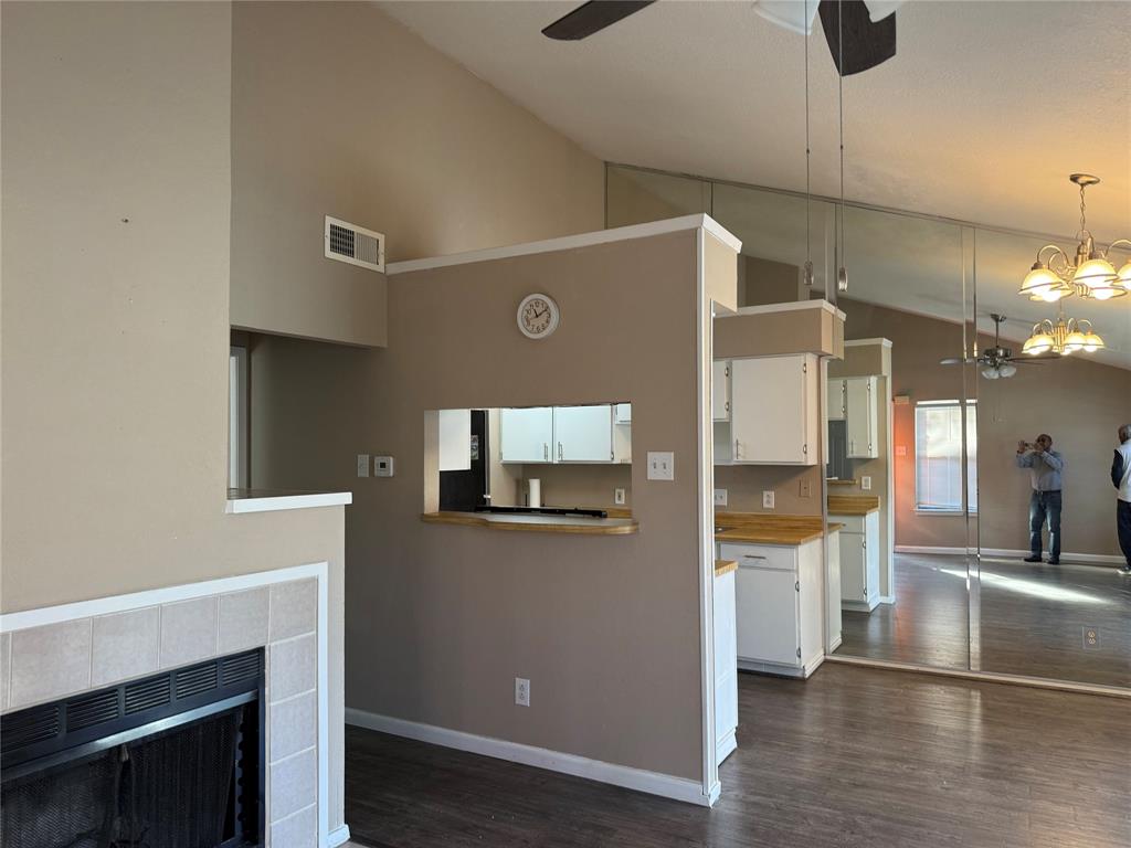 2240 Tarpley Road, Unit 31 Carrollton, TX 75006 - Photo 9 of 18 a view of a kitchen with a sink wooden floor and a living room