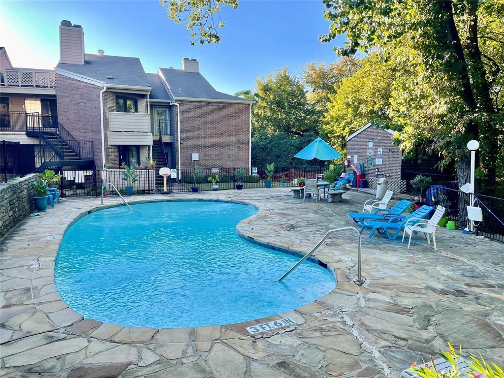 8545 Midpark Road, Unit 11 Dallas, TX 75240 - Photo 15 of 18 a view of a house with backyard porch and sitting area