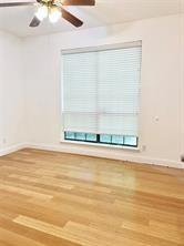 8545 Midpark Road, Unit 11 Dallas, TX 75240 - Photo 8 of 18 a view of a room with wooden floor and a window