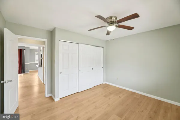a view of a hallway with a ceiling fan