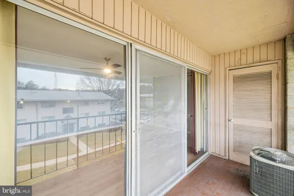 view of a hallway with wooden floor and windows