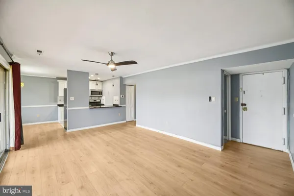 a view of a kitchen with a sink and a refrigerator