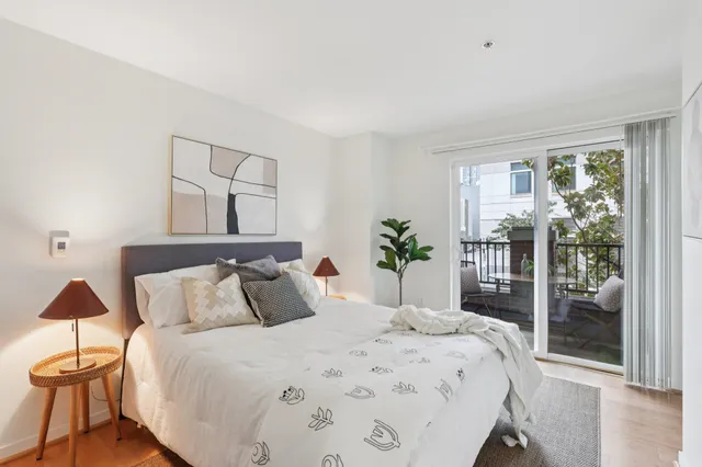 a view of a kitchen with kitchen island a sink wooden floor and a chandelier