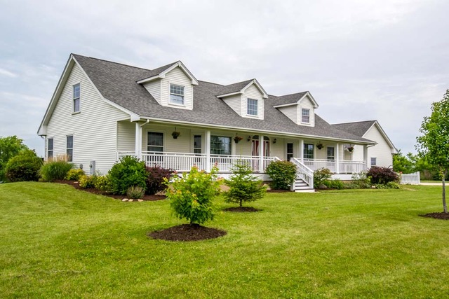 a front view of a house with a yard and porch