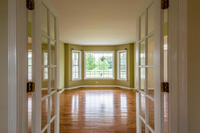 12N330 Switzer Road Elgin, IL 60124 - Photo 11 of 25 a view of empty room with wooden floor and floor to ceiling window